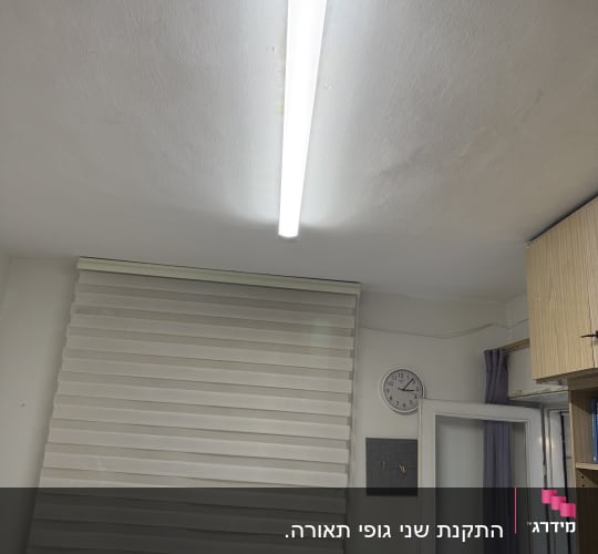 מנורת פלורסנט מותקנת בתקרה בחדר מגורים